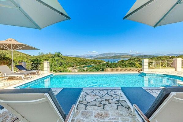 Outdoor pool, a heated pool, pool umbrellas, sun loungers