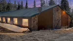 A rustic cabin with a metal roof, large windows, and a stone exterior. - Beautiful Ski-in/ski-out Condo Located On The Eagle Point Resort! 1 Bedroom Condo by RedAwning (Beaver)