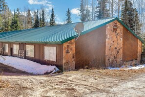 A rustic cabin with a green metal roof, wooden walls, and a satellite dish. - Beautiful Ski-in/ski-out Condo Located On The Eagle Point Resort! 1 Bedroom Condo by RedAwning (Beaver)