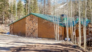 A rustic wooden building with a stone facade, surrounded by trees and a dirt road. - Beautiful Ski-in/ski-out Condo Located On The Eagle Point Resort! 1 Bedroom Condo by RedAwning (Beaver)