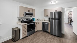 A modern kitchen with stainless steel appliances, wooden cabinets, and a built-in oven. - Beautiful Ski-in/ski-out Condo Located On The Eagle Point Resort! 1 Bedroom Condo by RedAwning (Beaver)