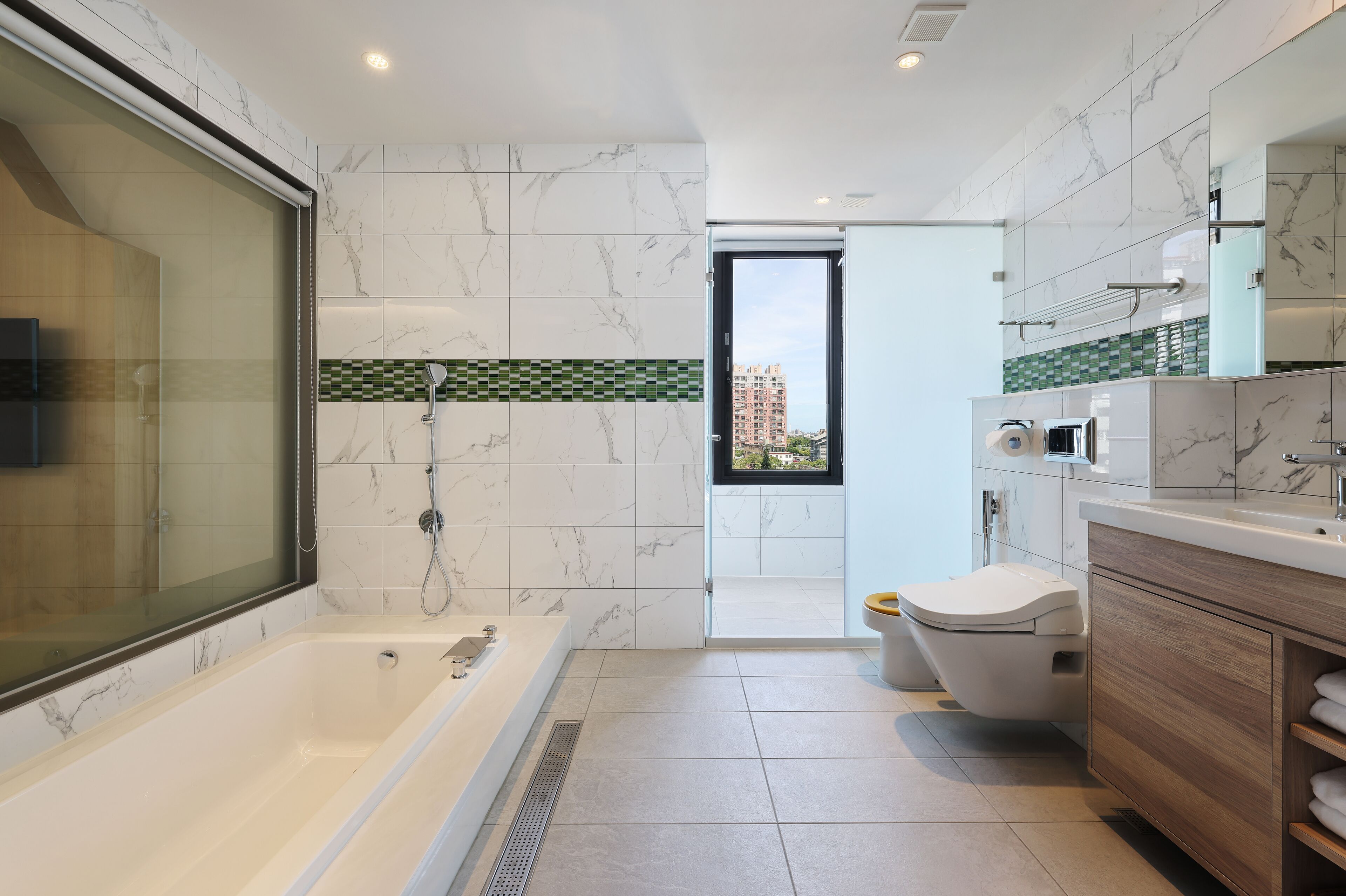 deluxe quadruple room | bathroom | hair dryer, towels, shampoo, toilet paper