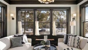 A room with two white sofas, a round coffee table, and a large window with curtains. - Luxury 6600 sq.ft Stunning Home/Sleeps 10+ (Minneapolis)
