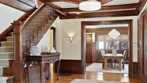 A spacious foyer with a grand staircase, a dining area with a chandelier, and a modern light fixture. - Luxury 6600 sq.ft Stunning Home/Sleeps 10+ (Minneapolis)