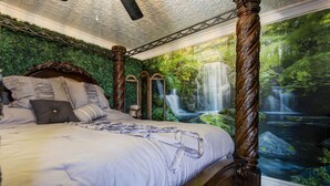 A bedroom with a four-poster bed, a green wall, and a waterfall mural. - The Key to your Heart (Nixa)