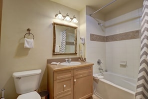 A bathroom with a toilet, sink, vanity, mirror, shower, and a towel rack. - Perfect Ski Condo Steps from the Super Bee & Golf Course - CS325 by Redawning (Copper Mountain)