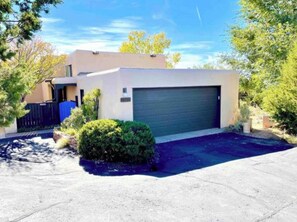 Set amidst a well-manicured lawn, this single-story residence offers a driveway and a garage door.