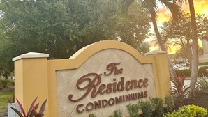 A sign for 'The Residence Condominiums' with a landscaped garden in front. - LOVELY RESIDENCE CONDO TROPICAL RETREAT! (Fort Myers)