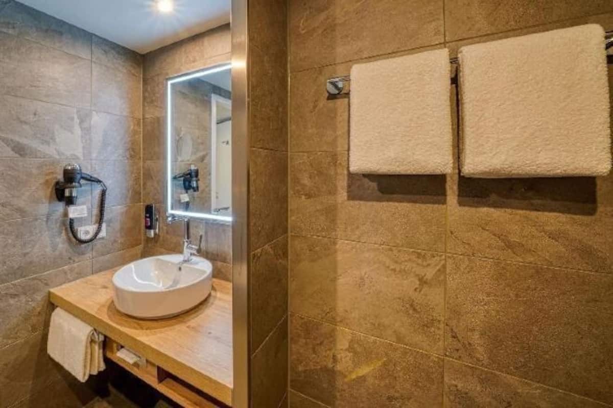 Bathroom | Shower, rainfall showerhead, hair dryer, towels