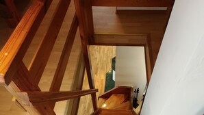 A wooden staircase with a view of a room at the top. - Apartamenty Swinoujscie - Rubin I (Swinoujscie)
