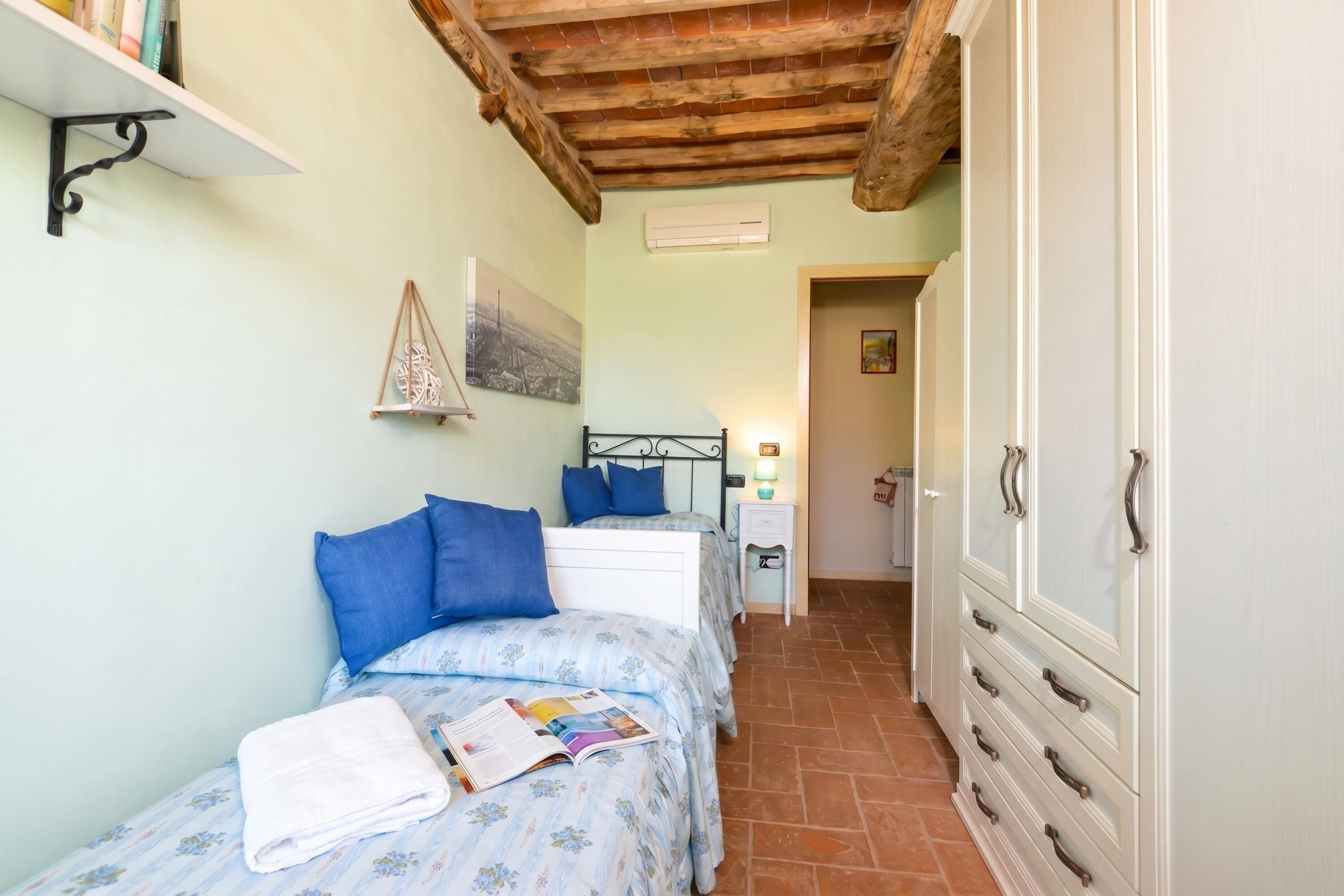A bedroom with a bed, bedside table, and wardrobe.