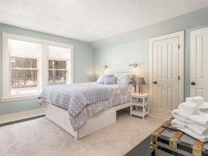 A bedroom with a bed, bedside tables, a window, and a door. - Sunday River Getaway (Newry)