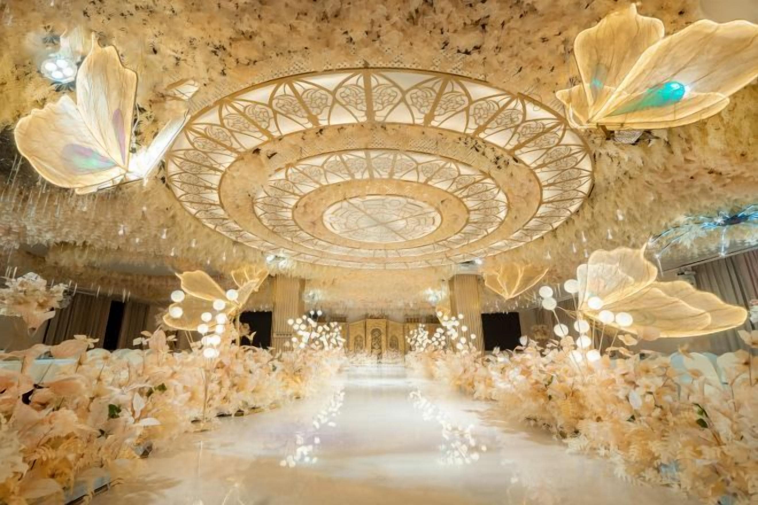An ornate hall with a central circular design, floral decorations, and a reflective floor.