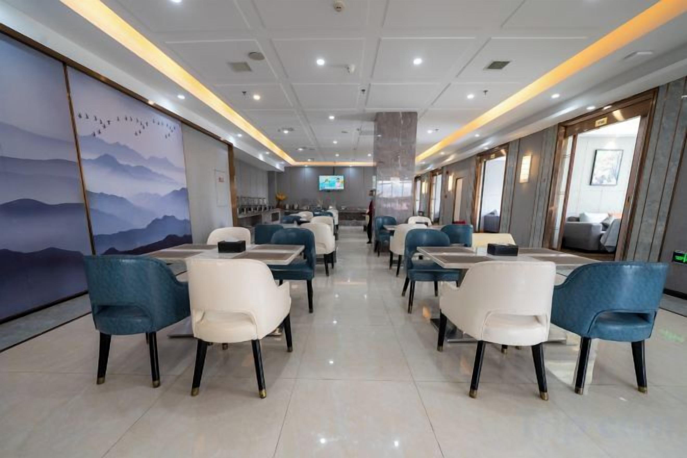 A modern restaurant with a long counter and multiple seating areas.
