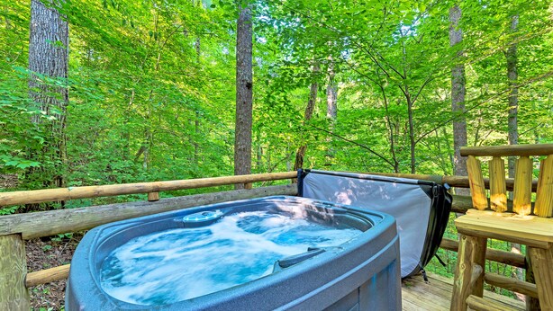 A hot tub on a wooden deck surrounded by a forest. - GREAT EXPECTATIONS - 2 Bdrm/2 Bath, wood burning fireplace, secluded, Laurel Valley (Townsend)