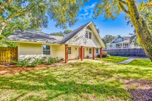 A two-story house with a front porch, a covered entryway, and a well-maintained lawn.