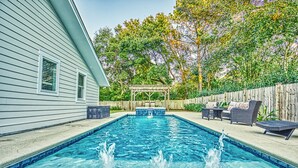 A rectangular swimming pool with a wooden deck and lounge chairs. - 2-Min Walk to Beach, Free Pool and Spa Heat, Family & Dog-Friendly, Sleeps 17, Kids' Loft (Hilton Head Island)