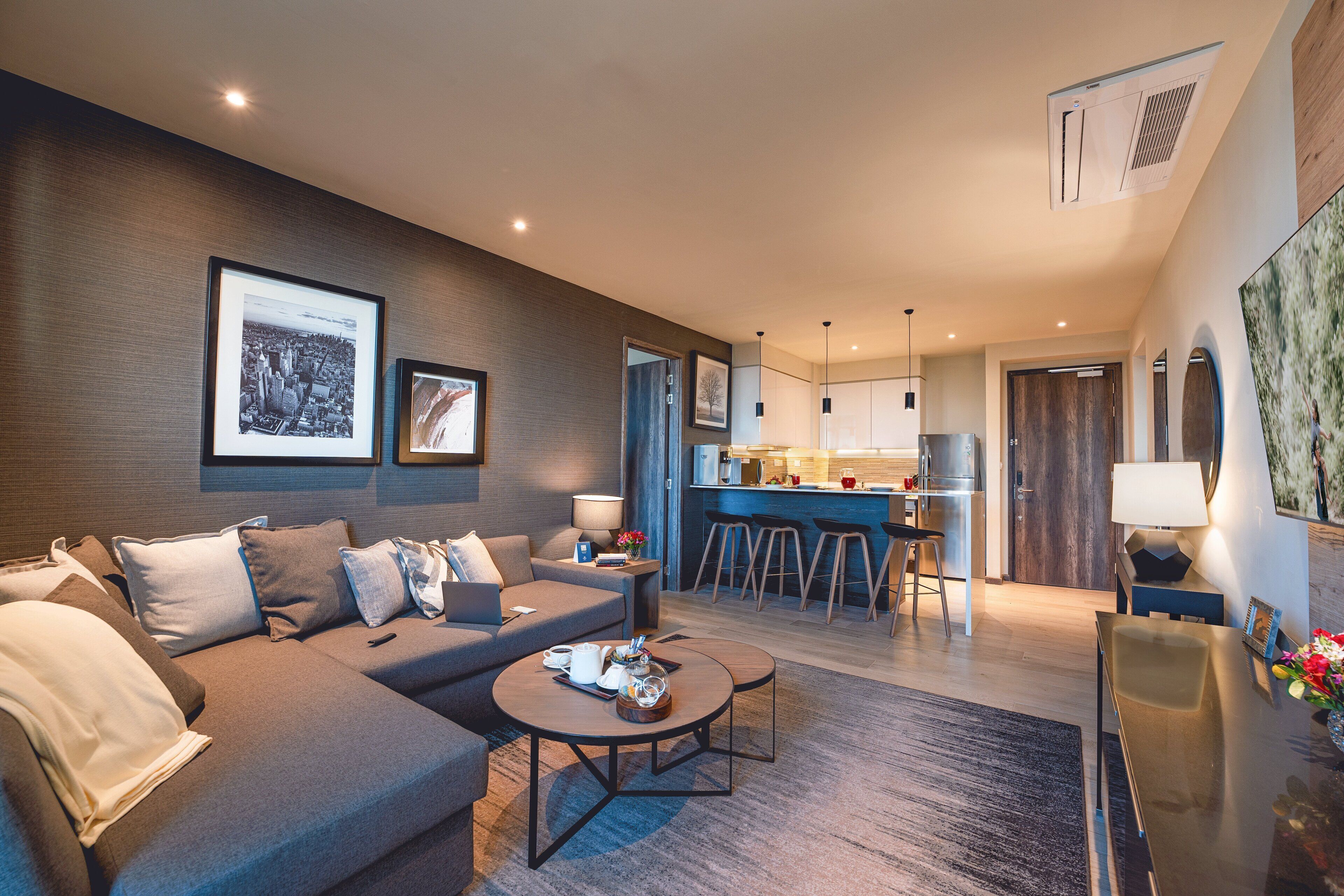 A modern living room with a sofa, coffee table, and artwork on the walls.