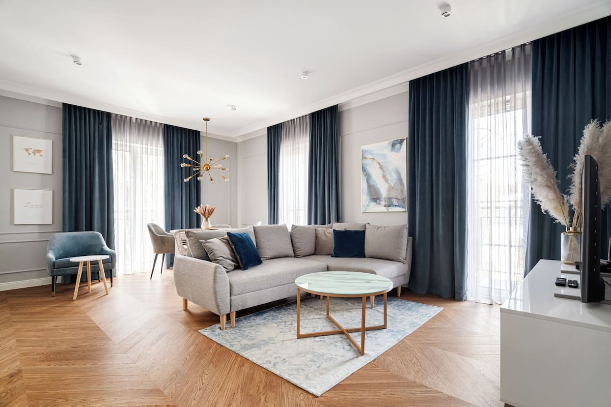 A modern living room with a sofa, coffee table, and chairs.