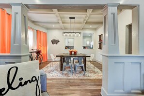 A dining area with a wooden table, chairs, and a chandelier. - Cottage Chic- Less than 5 mins to Plaza District (Oklahoma City)