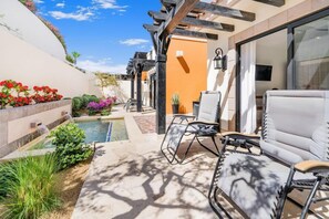 A patio with outdoor seating, a small pool, and a garden with various plants and flowers. - Quivira Ocean view private villa with pool (Cabo San Lucas)