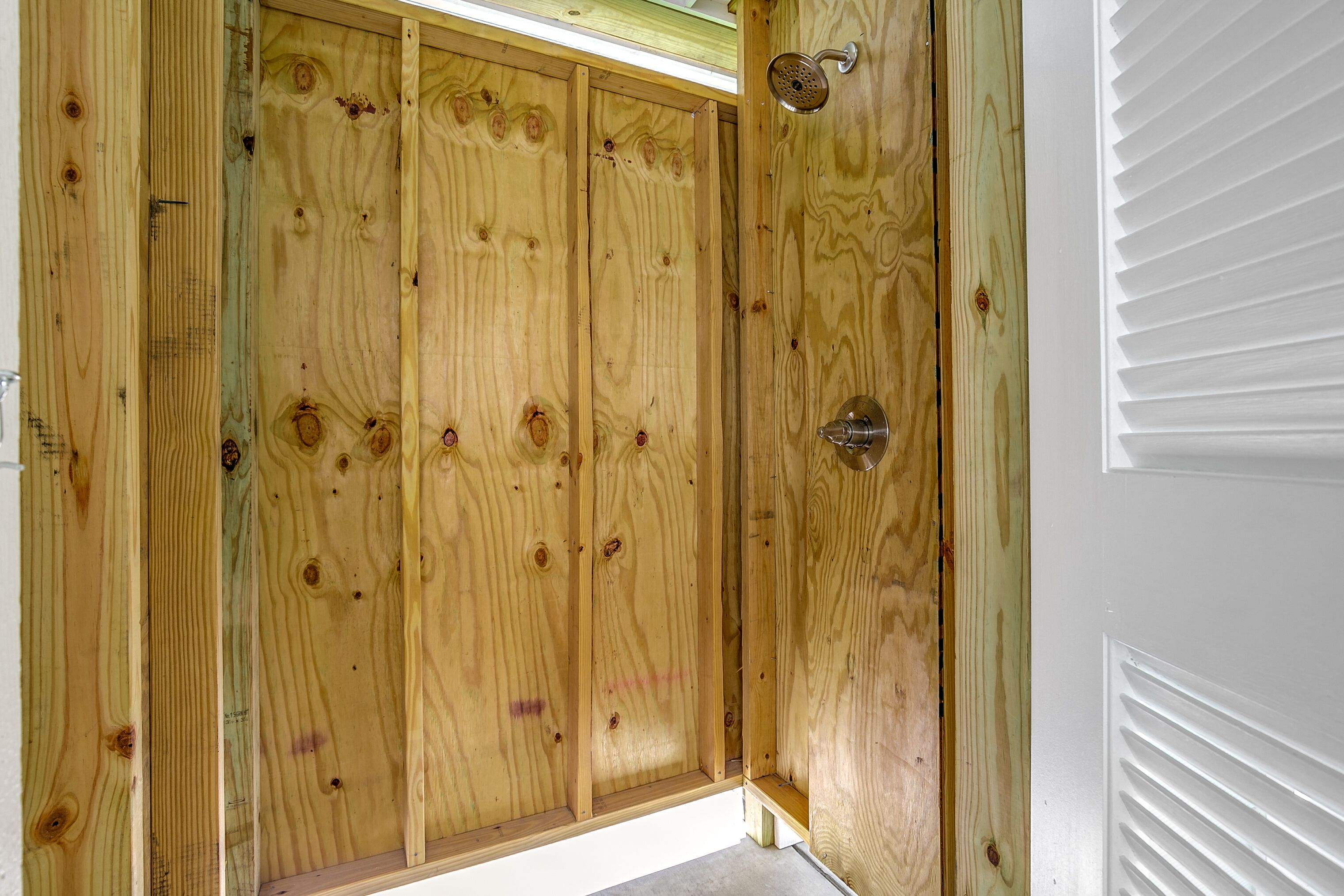 A wooden door with a metal handle and a white door frame.