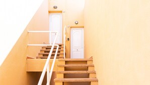A set of wooden stairs leading to a white door with a small mailbox above it. - Private Terrace Home - Pool - Wifi (Costa Calma)