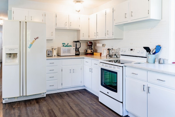 Enjoy cooking in this well-equipped kitchen with an oven, microwave, and coffee maker.