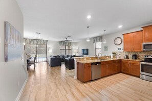 Enjoy meals in the kitchen with stainless steel appliances and a granite countertop, then dine in the adjacent seating area with a view of the outdoor patio.