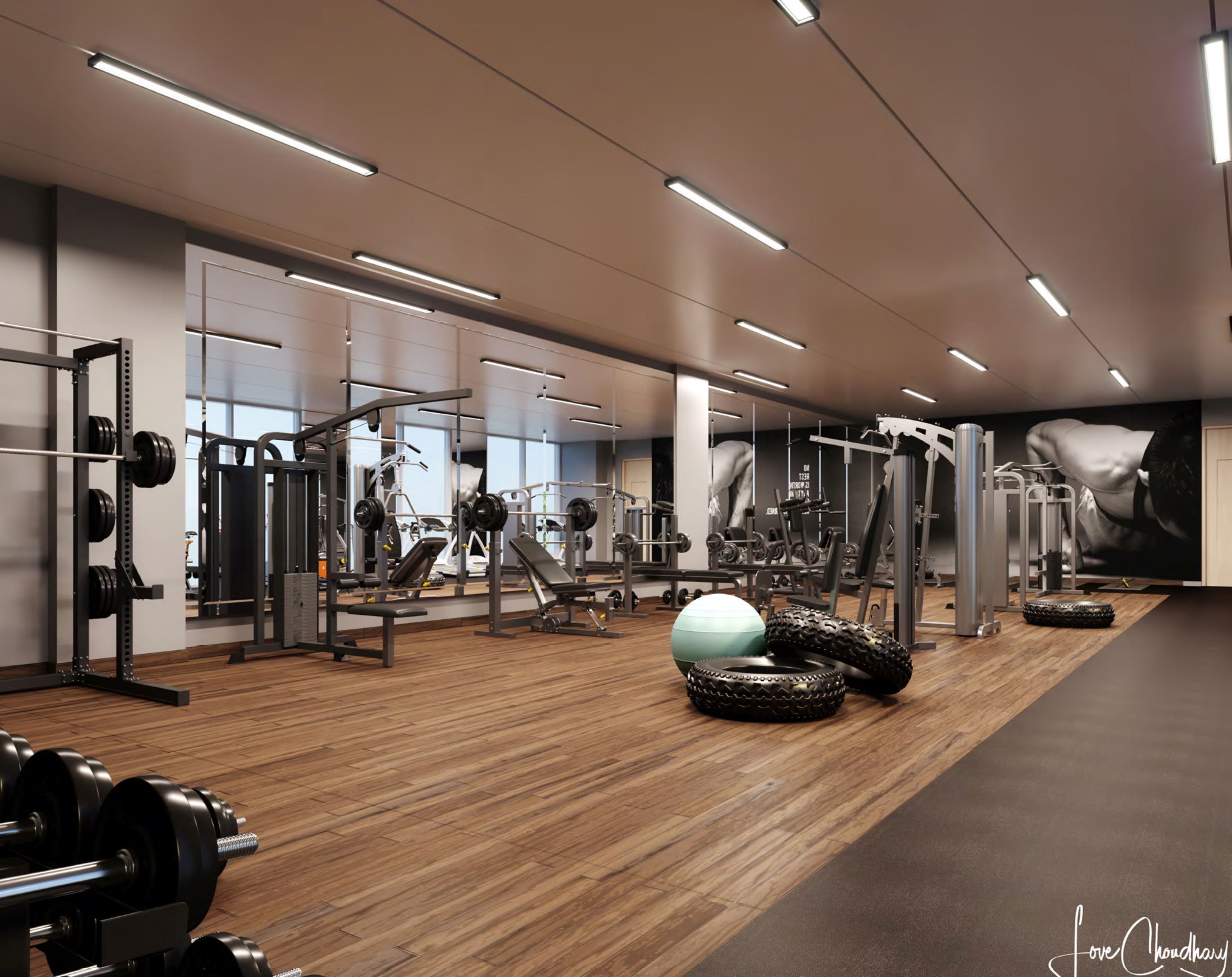 A modern gym with various exercise equipment, a large mirror, and a wooden floor.