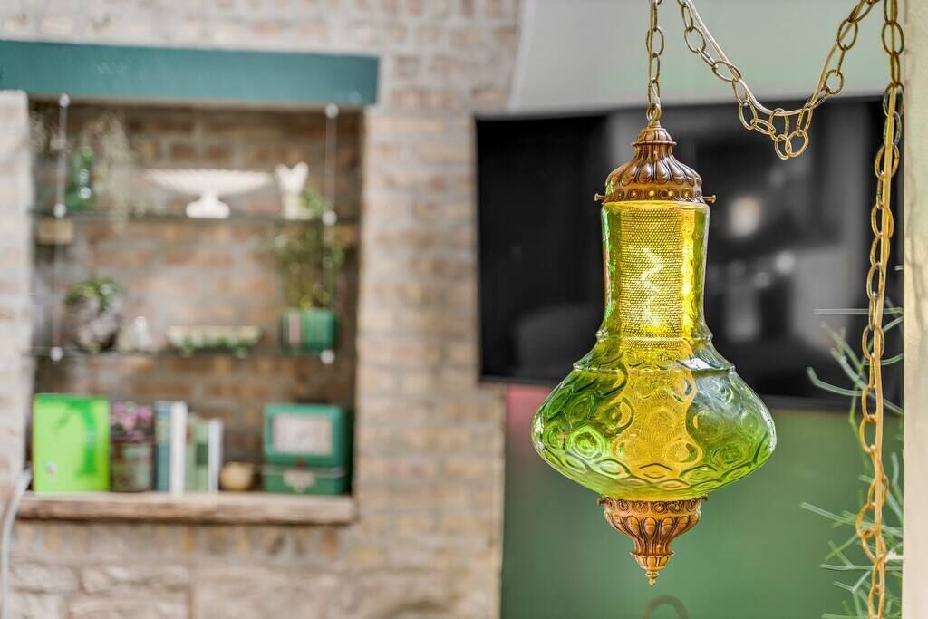 A hanging lantern with a textured surface and a chain.