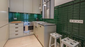 A modern kitchen with a built-in oven, a sink, and a countertop.