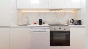 A modern kitchen with a dishwasher, stove, and toaster.