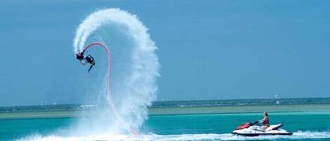 A jet ski performing a stunt with a wake behind it.
