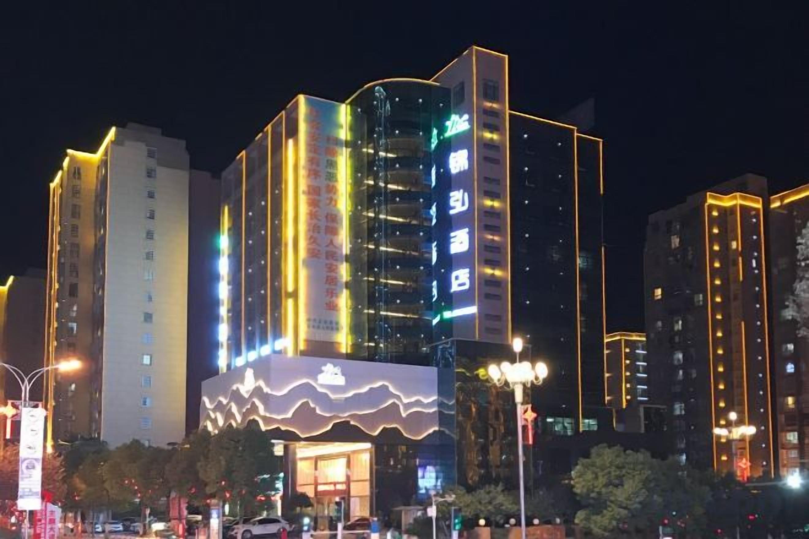 A brightly lit hotel with multiple floors and a prominent entrance.