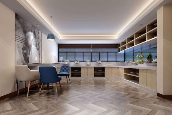 A modern kitchen with a herringbone floor pattern, built-in shelves, and a central island.