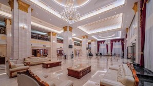 A luxurious lobby with marble floors, ornate columns, and elegant seating areas. - Dong Zheng International Hotel (Hechi)