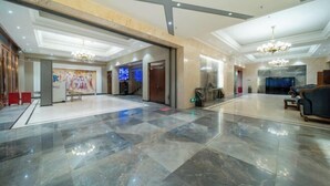 A spacious lobby with a marble floor, a chandelier, and a seating area with sofas. - Lingyu International Boutique Hotel (Jinghe)