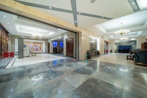 A spacious lobby with a marble floor, a chandelier, and a seating area with sofas. - Lingyu International Boutique Hotel (Jinghe)