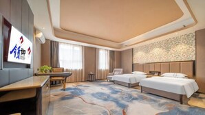 A hotel room with a large bed, a desk, a chair, and a TV. - Lingyu International Boutique Hotel (Jinghe)