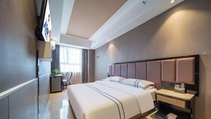 A modern hotel room with a large bed, bedside tables, a desk, and a TV. - Lingyu International Boutique Hotel (Jinghe)