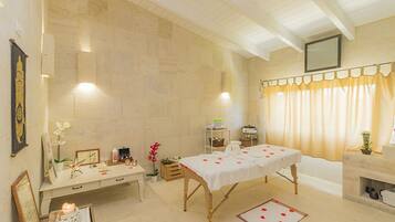 Experience a serene spa retreat with a massage table, elegant decor, and a soothing ambiance.