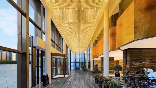A spacious lobby with a high ceiling, large windows, and a modern chandelier. - Botai Hotel (Yongqing)