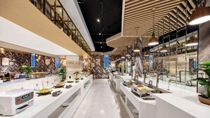 A modern hotel lobby with a central reception desk, multiple seating areas, and a high ceiling with exposed beams. - Botai Hotel (Yongqing)