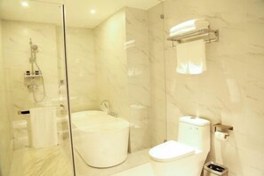 A modern bathroom with a glass-enclosed shower, a standalone bathtub, and a toilet. - Botai Hotel (Yongqing)