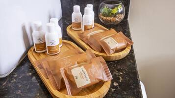 A bathroom counter with toiletries and a small plant.