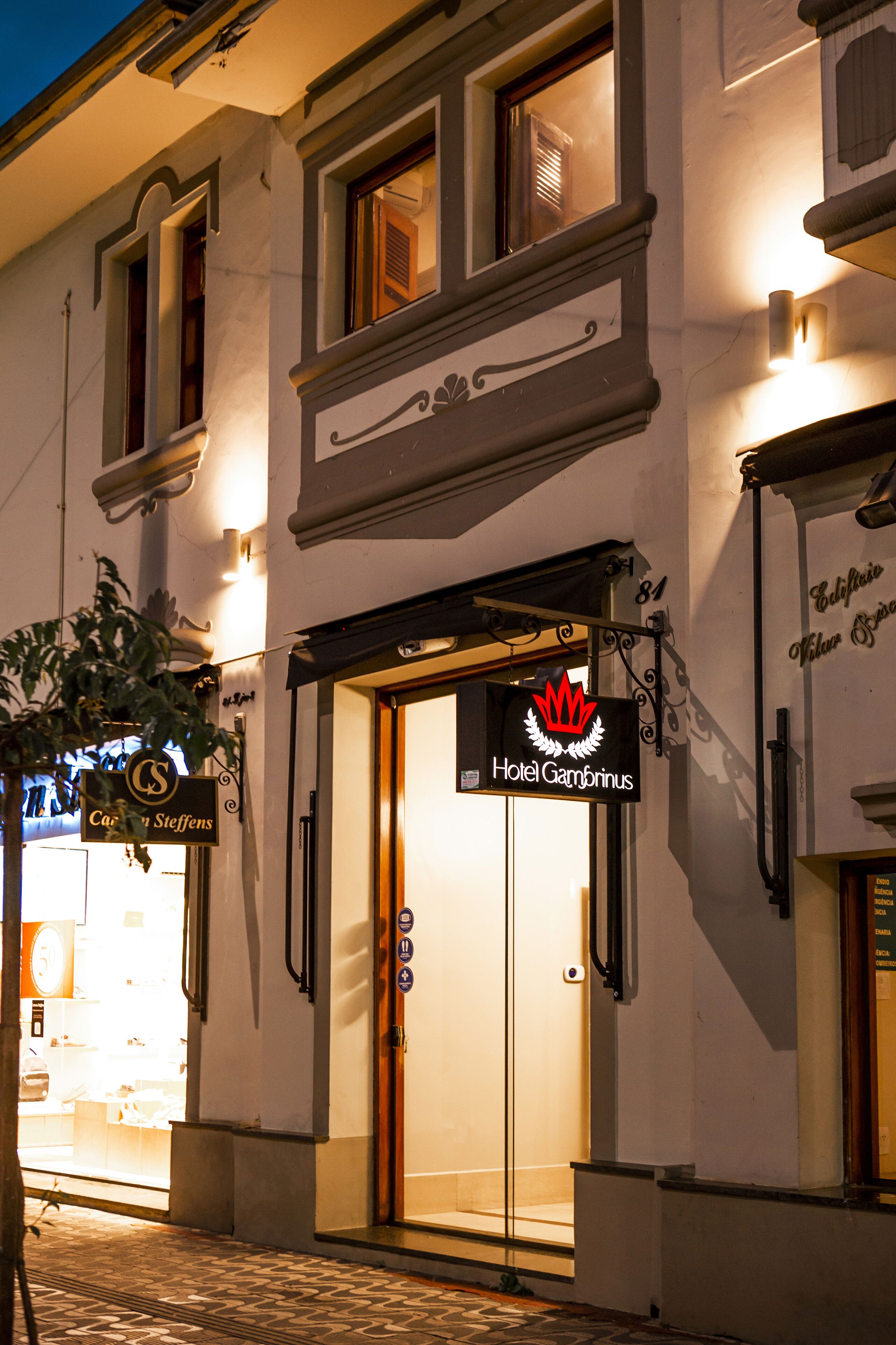 A hotel entrance with a sign reading "Hotel Gambrinus."