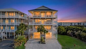 A multi-story hotel with balconies, a covered entrance, and a landscaped driveway. - Papa’s Porch, 8BR Beach House, Private Pool, Elevator, Sleeps 20 (Ocean Isle Beach)