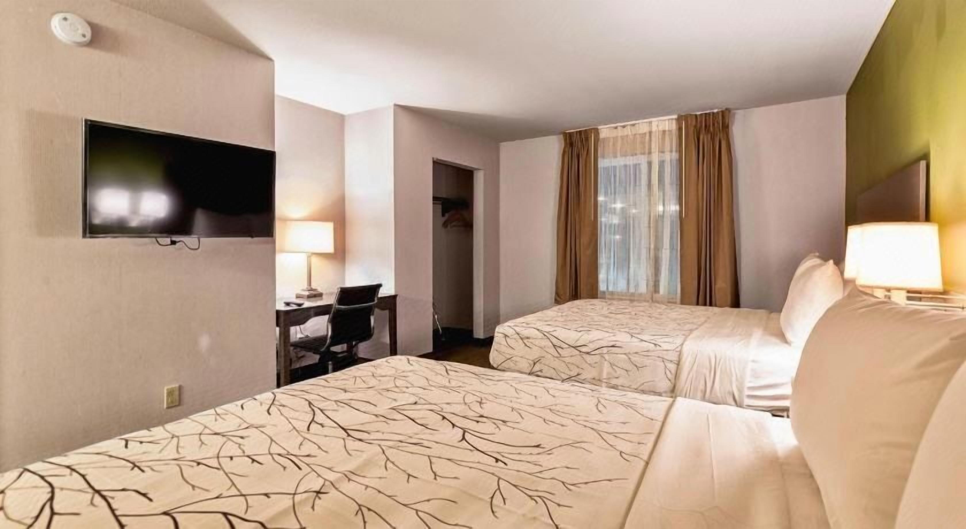 Premium bedding, desk, laptop workspace, blackout drapes