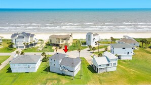 An aerial view of a coastal residential area with houses, a beach, and a clear sky. - 2nd Row Gulf View Home w/ 2 Decks, Board Games, 3 Kings+Bunk all w/Deck Access (Galveston)